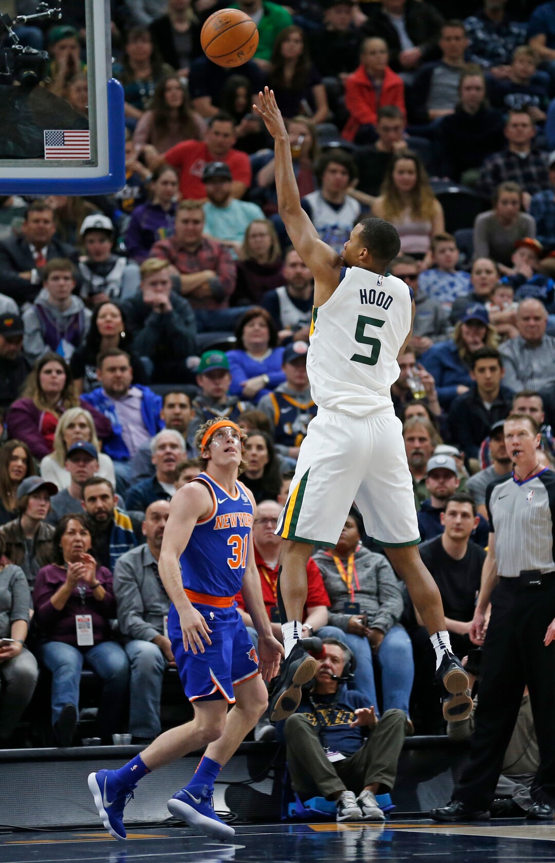Utah Jazz guard Rodney Hood (5) shoots as New York Knicks guard Ron Baker (31) watches during the first half of an NBA basketball game Friday, Jan. 19, 2018, in Salt Lake City. (AP Photo/Rick Bowmer)