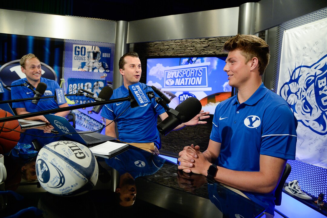(Francisco Kjolseth  |  The Salt Lake Tribune)  BYU Sports Nation hosts Spencer Linton, left, and Jarom Jordan speaks with quarterback Zach Wilson during BYU football media day at the BYU Broadcasting Building in Provo on Tuesday, June 18, 2019.