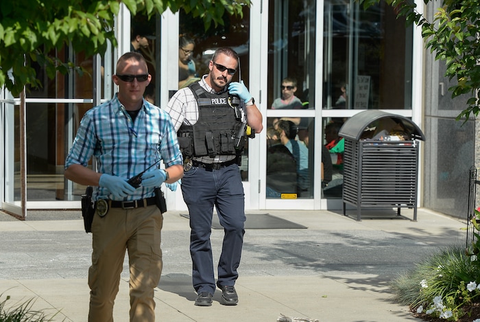 (Francisco Kjolseth  |  The Salt Lake Tribune)  Activists stage a protest against a private prison company with contracts to hold undocumented immigrants on Thursday, July 12, 2018, after locking themselves in the lobby at the headquarters of Management and Training Corporation in Centerville.