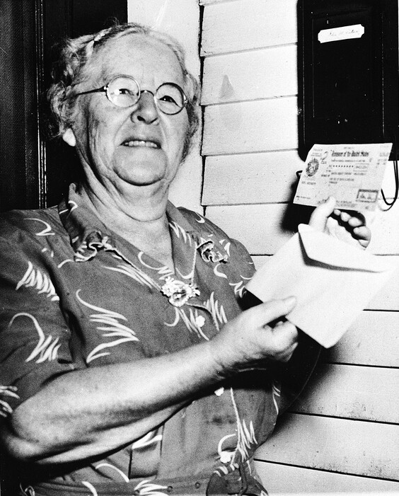 FILE - In this Oct. 4, 1950 file photo, Ida May Fuller, 76, displays a Social Security check for $41.30 that she received at her home in Ludlow Vt.  On Jan. 31, 1940, Fuller received the country's first Social Security check for $22.54. By the time she died in 1975 at age 100, she had received nearly $23,000 in benefits.  (AP Photo, File)