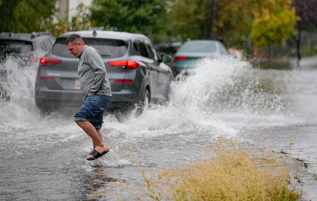 (Francisco Kjolseth | The Salt Lake Tribune) Residents walk the flooded streets of their neighborhood as flood damage is seen to dozens of homes near 800 North and Sir Philip Drive, just east of Interstate 215, on Saturday, Oct. 4, 2024.