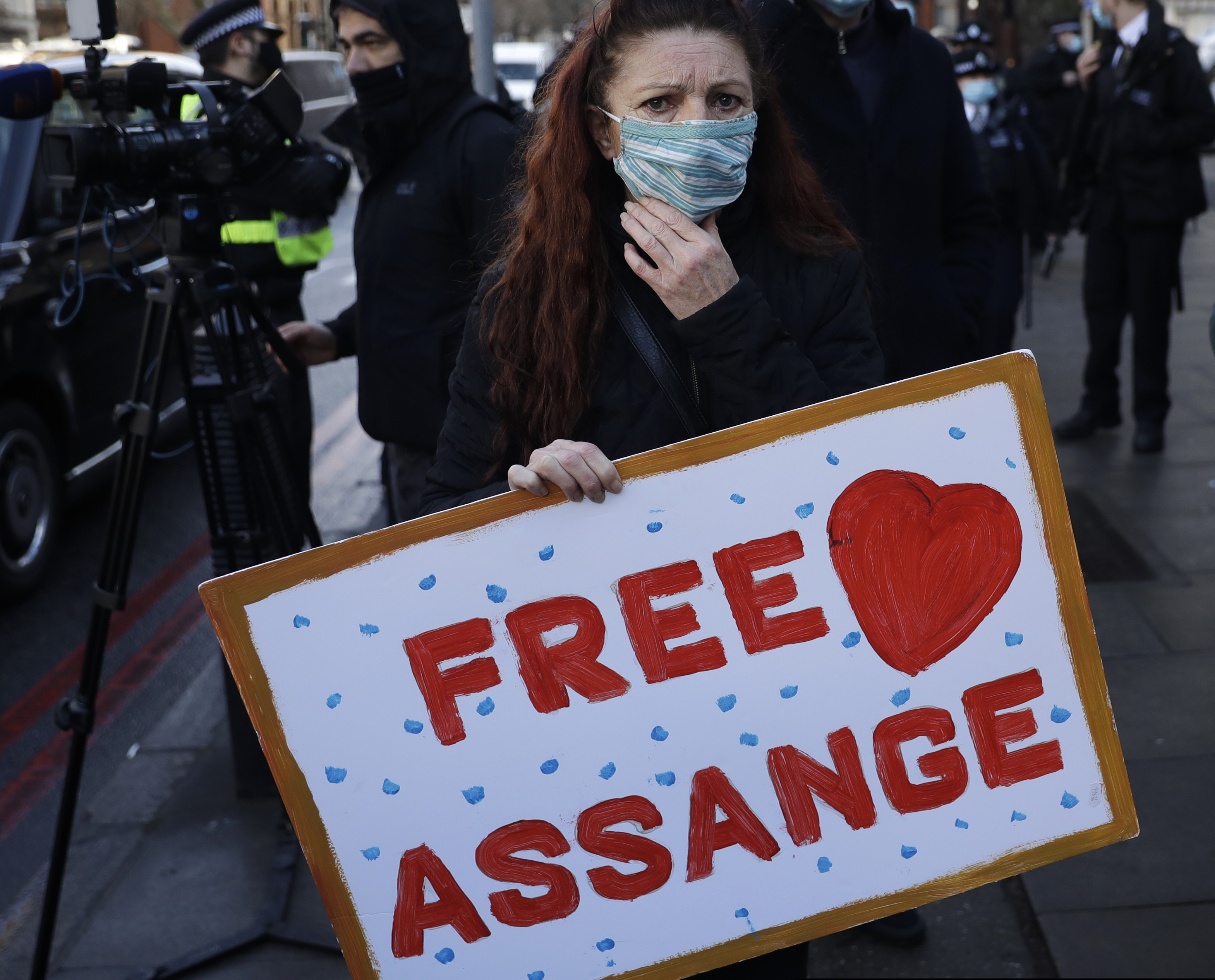 A Julian Assange supporter reacts outside the Westminster Magistrates Court after Julian Assange was denied bail at a hearing in the court in London, Wednesday, Jan. 6, 2021. (AP Photo/Matt Dunham)