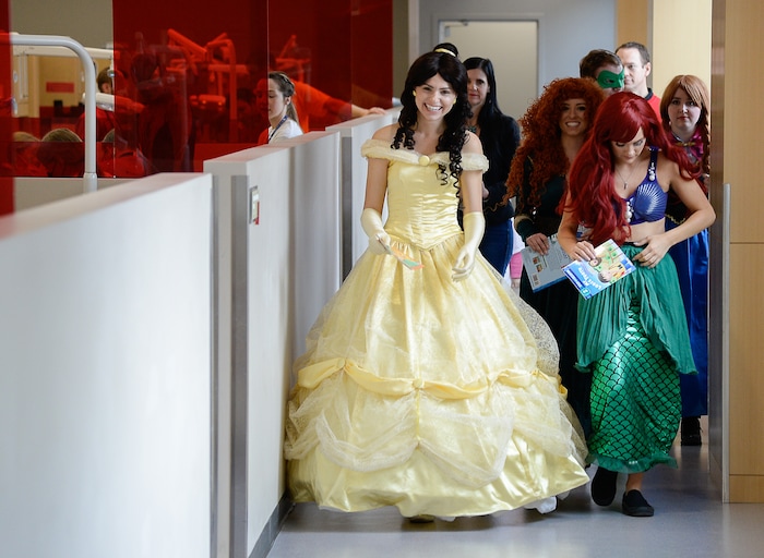 (Francisco Kjolseth  |  The Salt Lake Tribune) Marina McNeill, center, playing the role of Belle, organizes a team of superheroes and princesses as part of the service group she started 6-years ago called Service Opportunities 101. The team of volunteers helped calm the nerves of young kids receiving free dental care at the University of Utah dental school, as part of the American Dental AssociationÕs ÒGive Kids a SmileÓ program on Saturday, Feb. 29, 2020.