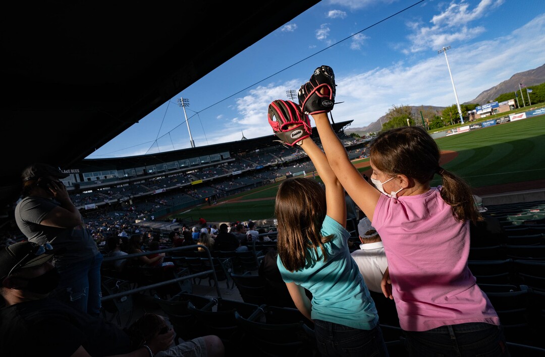 (Francisco Kjolseth | The Salt Lake Tribune) Twin sisters Emmersyn and Connelly Ogden, 8, keep their gloves at the ready as they attend the Salt Lake Bees home opener at Smith’s Ballpark Thursday night, May 6, 2021, after shutting down last season due to the pandemic.