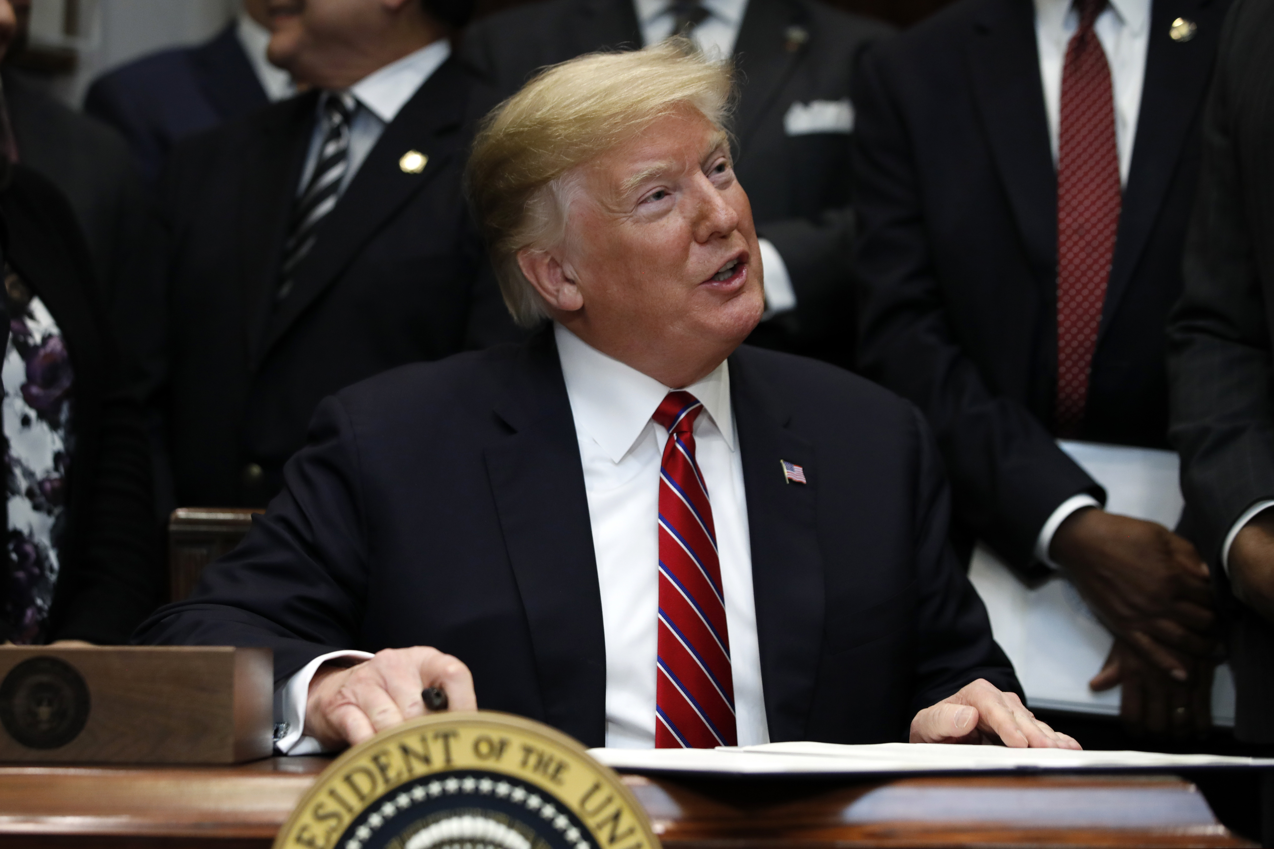 (Jacquelyn Martin | AP Photo) President Donald Trump speaks as he signs an executive order establishing the White House Opportunity and Revitalization Council, in the Roosevelt Room of the White House, Wednesday Dec. 12, 2018, in Washington.
