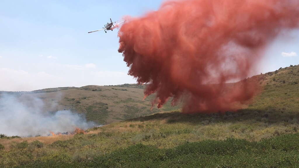 (Photo courtesy Bureau of Land Management) A plane drops retardant on the China Jim Fire in Box Elder County.