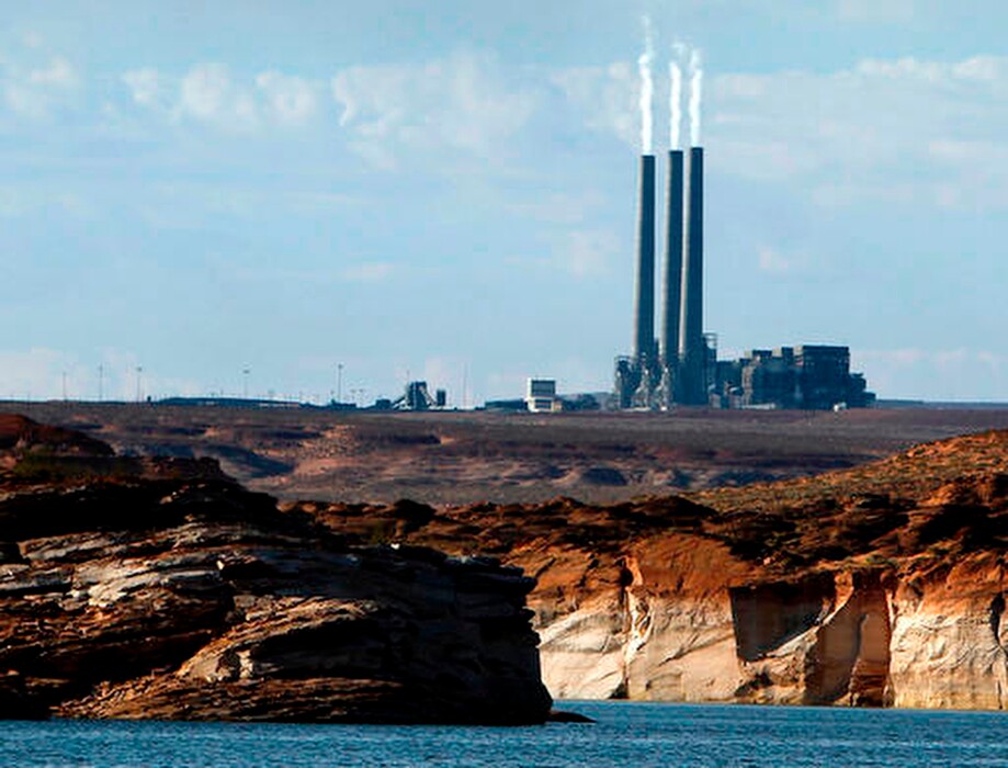 (Ross D. Franklin | AP file photo) In this Sept. 4, 2011, file photo, smoke rises from the stacks of the main plant facility at the Navajo Generating Station, as seen from Lake Powell in Page, Ariz. The owners of one of the largest coal-fired power plants in the West say negotiations with a tribe to take over the plant have hit an impasse. A Navajo Nation energy company has been talking with owners of the Navajo Generating Station to buy the plant that's scheduled to shut down in December.