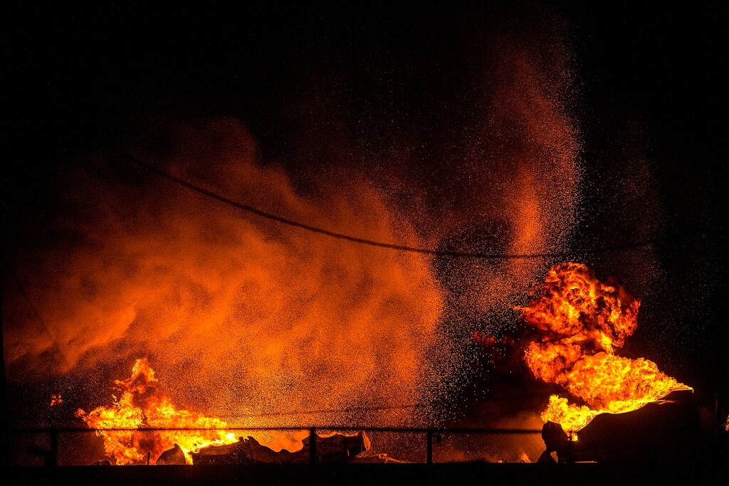 (Chris Detrick | The Salt Lake Tribune) Firefighters attempt to put out a burning semitrailer that was hauling thousands of gallons of fuel on Interstate-15 in Midvale Thursday, January 18, 2018. Lt. Todd Royce of the Utah Highway Patrol said the truck was southbound on the interstate at 7500 South at 7:20 p.m. when a tire caught fire, sending flames toward the tanks.