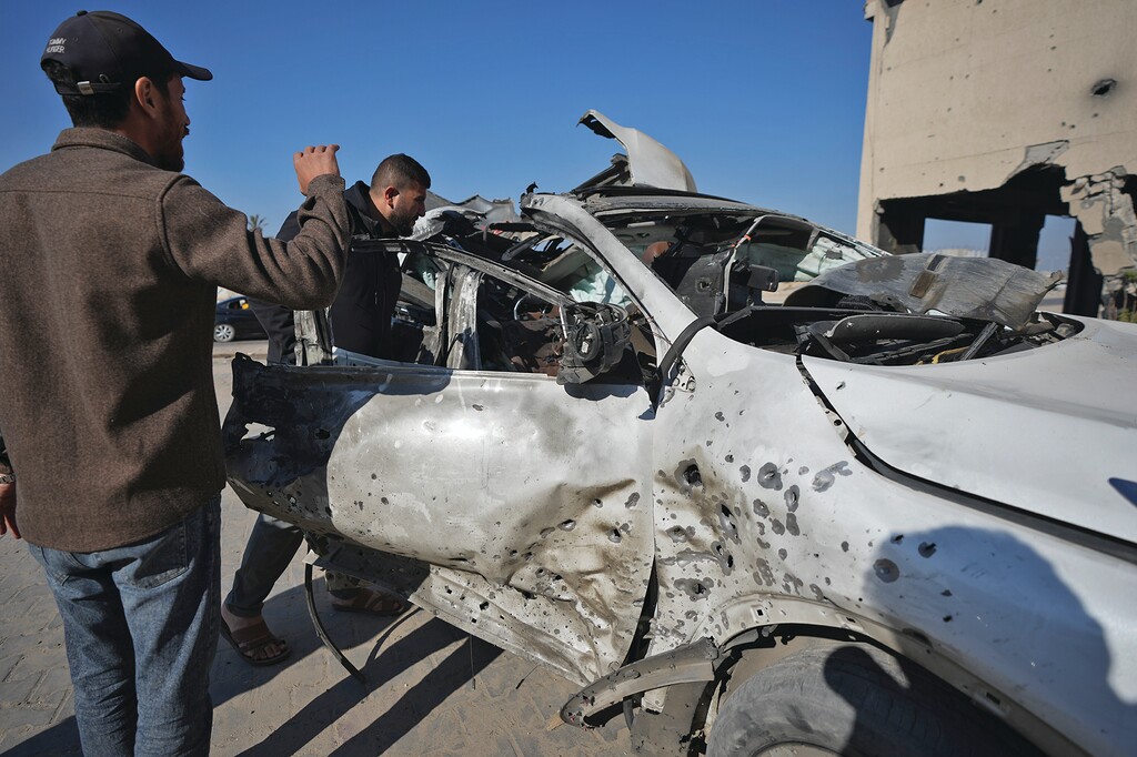 (Abdel Kareem Hana | AP) Palestinians inspect the car where, on Saturday, an Israeli airstrike killed five people, including three employees of World Central Kitchen in Khan Younis, Gaza Strip, Sunday Dec. 1, 2024.