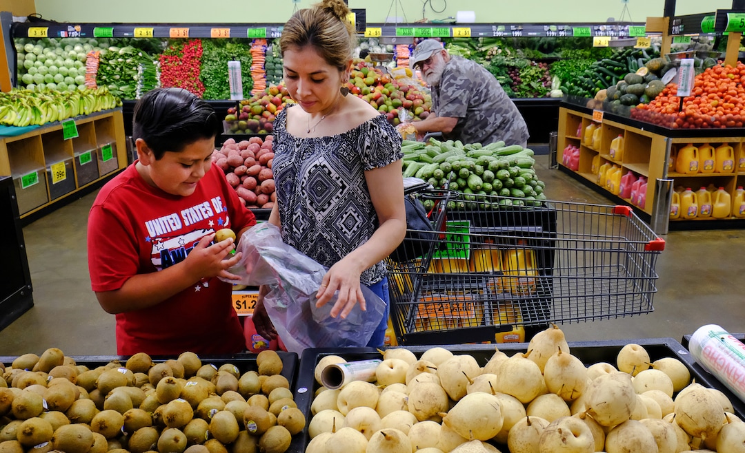 (Francisco Kjolseth  |  The Salt Lake Tribune)  Helizandro Mojica, 11, helps his mother Teresa Sotelo picking out fruits and vegetables on Wed. June 20, 2018, at Rancho Market at North Temple and 900 West, a chain that started in 2006 and now has 10 stores. The owner says half of their shoppers are Latino, and it caters to other immigrant groups and long-time residents. New Census numbers show a continuing growth of minorities in Utah. Minorities have grown by 132k since the 2010 Census in Utah, and the Latino population has grown by 76k since then.