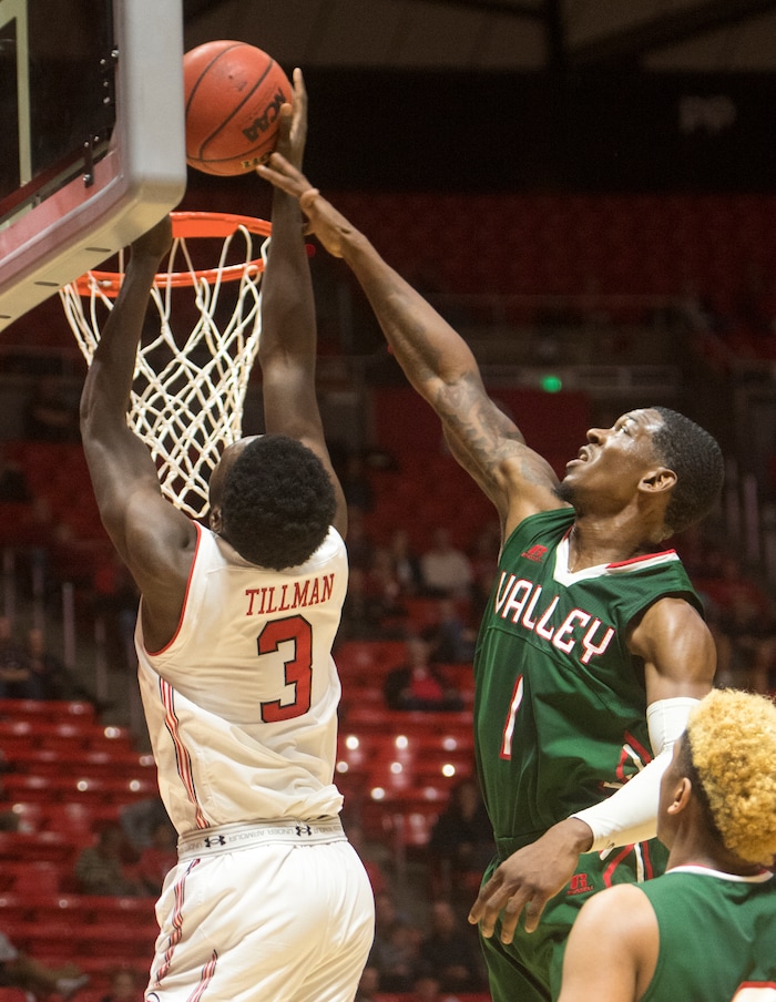(Rick Egan  |  The Salt Lake Tribune)  Utah Utes forward Donnie Tillman (3) dunks the ball, as Mississippi Valley State Delta Devils forward Dante Scott (1) defends, in basketball action Utah Utes vs. Mississippi Valley State Delta Devils, at the Jon M. Huntsman Center,  Monday, November 13, 2017.