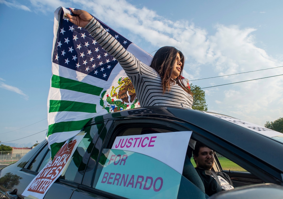(Rick Egan  |  The Salt Lake Tribune)     Dulce Vasquez follows protesters as they dance through the neighborhood in Rose Park, during the Dance Dance for Revolution protest for racial equality, on Sunday, Aug. 23, 2020. The protest was in memory of Jovany Mercardo who was shot last August by Ogden police by four officers, hitting his body sixteen times.