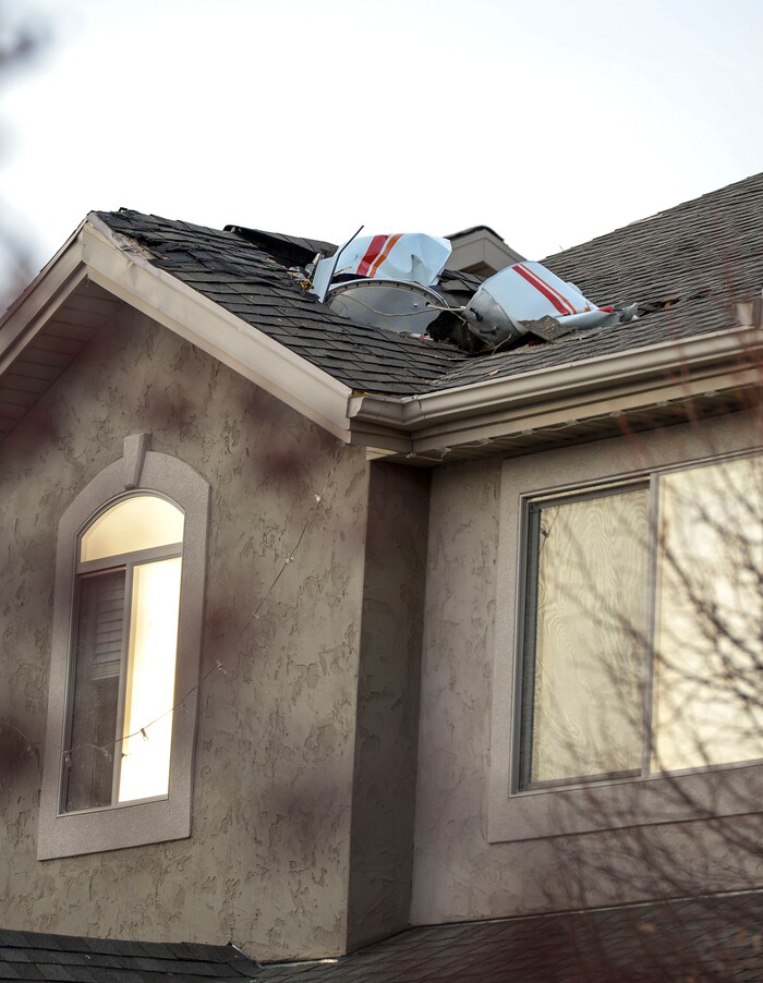 (Leah Hogsten | The Salt Lake Tribune) Weber County emergency personnel and firefighters work the scene of a small, private plane that crashed in a residential neighborhood in Roy, Jan 15, 2020. A 64-year-old pilot was killed.