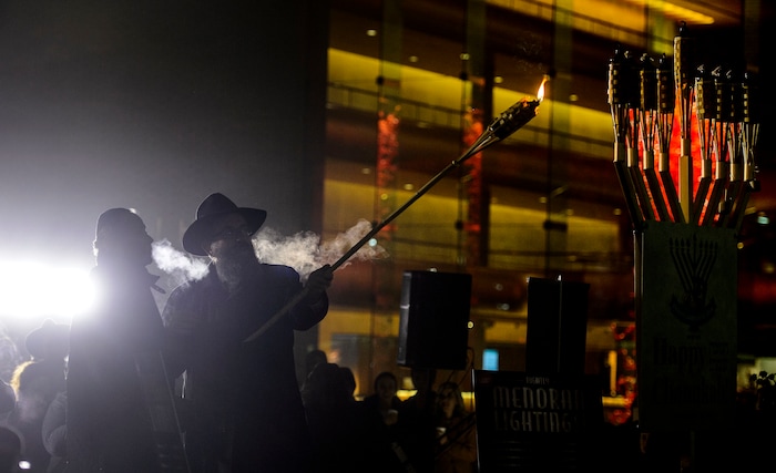 (Steve Griffin  |  The Salt Lake Tribune)   Rabbi Benny Zippel of Chabad Lubavitch is joined by John Price as they prepare to light a giant menorah for the first night of Hanukkah, the Jewish eight day festival of lights outside, Abravanel Hall in Salt Lake City Tuesday December 12, 2017.