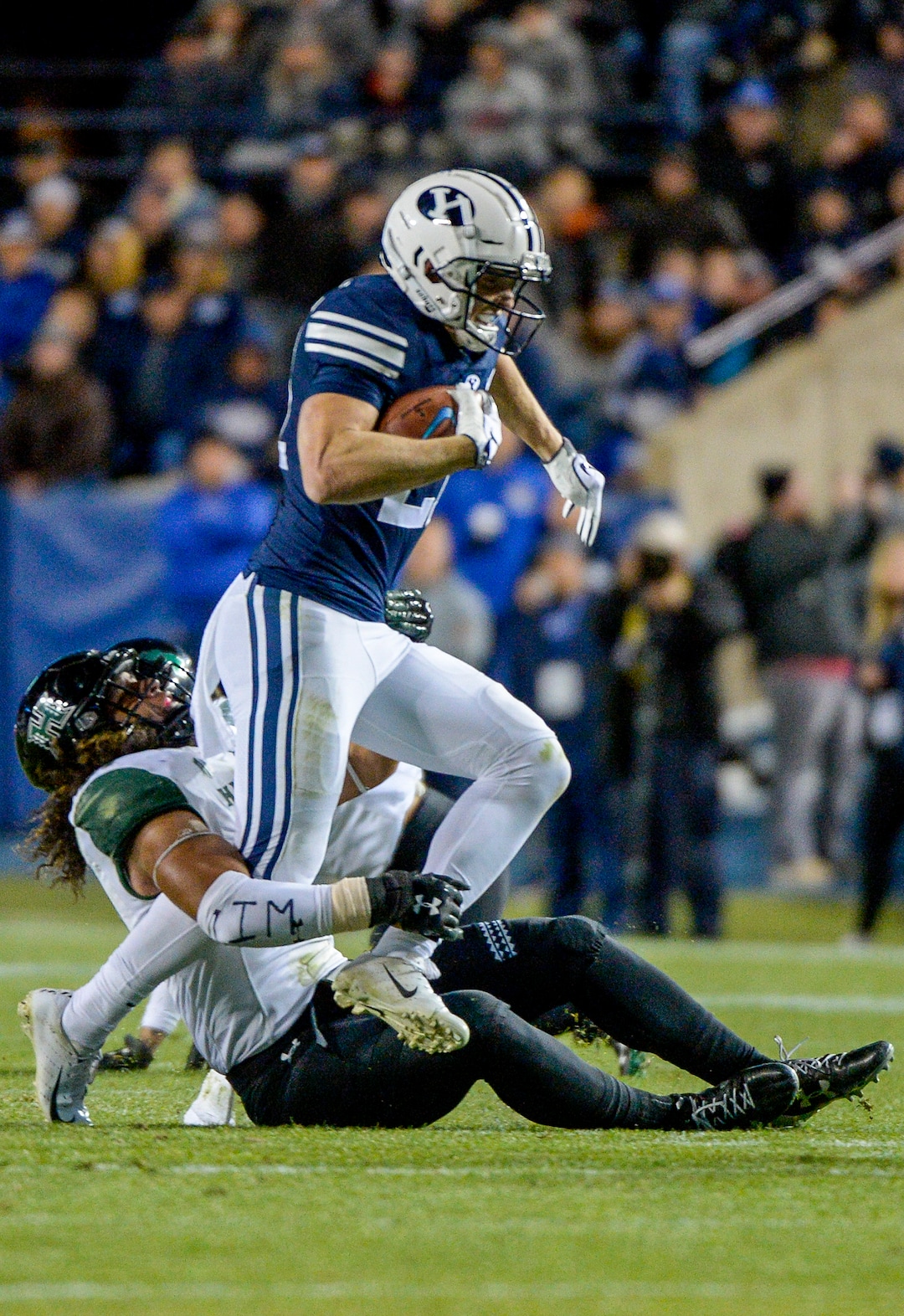 Leah Hogsten  |  The Salt Lake Tribune  Brigham Young Cougars wide receiver Talon Shumway (21) is brought down by Hawaii linebacker Jahlani Tavai (31) 3as Brigham Young University hosts Hawaii at Lavell Edwards Stadium in Provo, Saturday Oct. 13, 2018. 