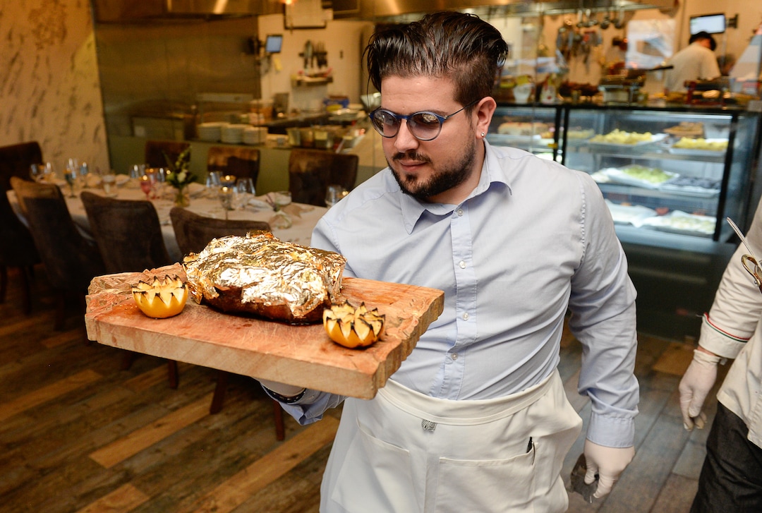 (Francisco Kjolseth  |  The Salt Lake Tribune) Giuseppe Mirenda at La Trattoria di Francesco, presents a steak covered in edible 24k gold and shaved truffles.