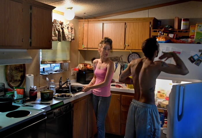 (Washington Post photo by Michael S. Williamson) "I have no sympathy for you," barks Maria to husband Phil. She warned him not to swipe a bite of pork from the frying pan while she was still cooking.