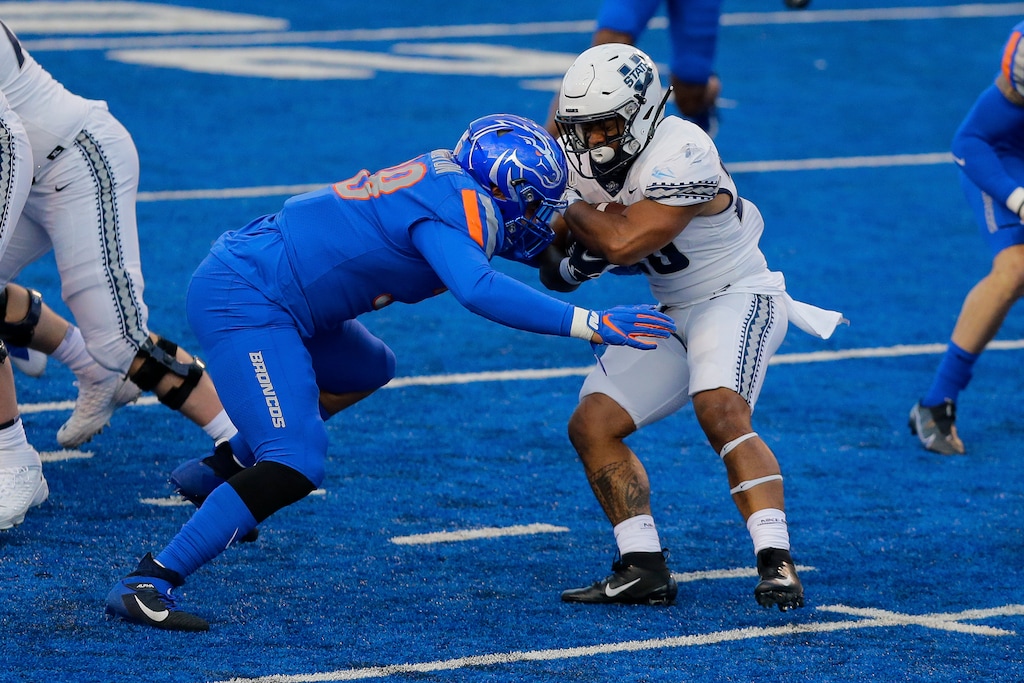 (AP Photo/Steve Conner) | Utah State running back Jaylen Warren (20) and the rest of the Aggies will try to get back on track under new interim coach Frank Maile on Saturday at Maverik Stadium againt Fresno State.