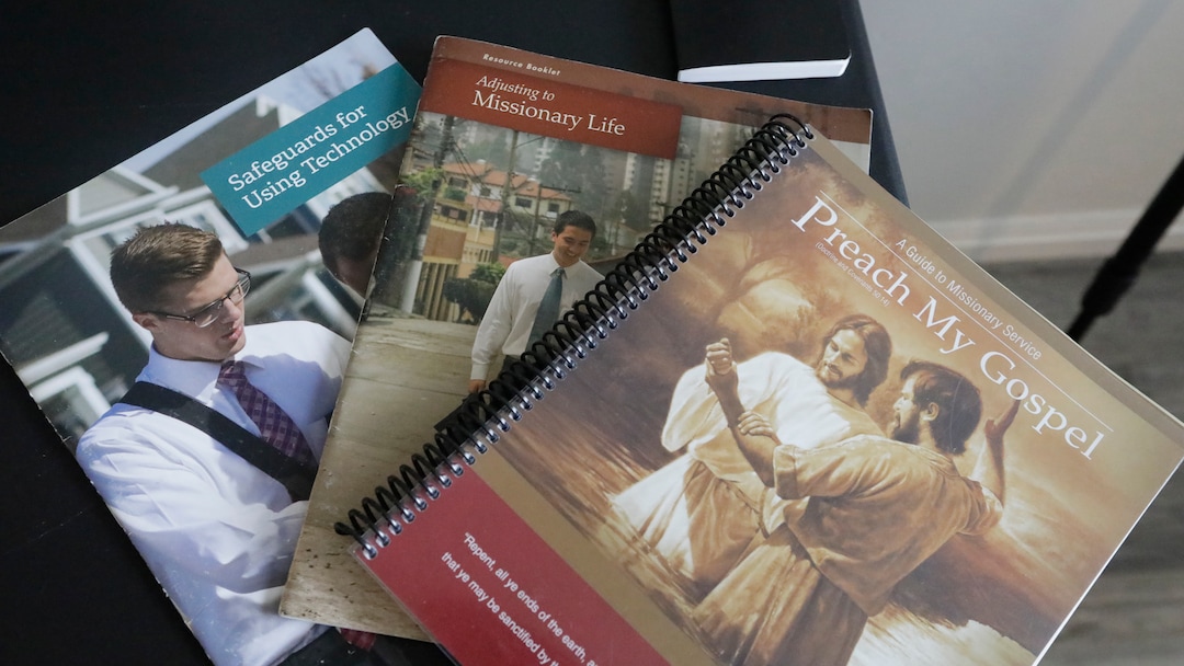 In this May 27, 2020, photo, several guides for missionary service sit on a desk at the apartment of missionaries with The Church of Jesus Christ of Latter-day Saints in Brigham City, Utah. After hastily bringing home 26,000 young men and women who were serving in foreign countries, the faith has begun sending many of them out again in their home countries with a new focus on online work that could stick even when the pandemic is over, church officials told The Associated Press. (AP Photo/Rick Bowmer)