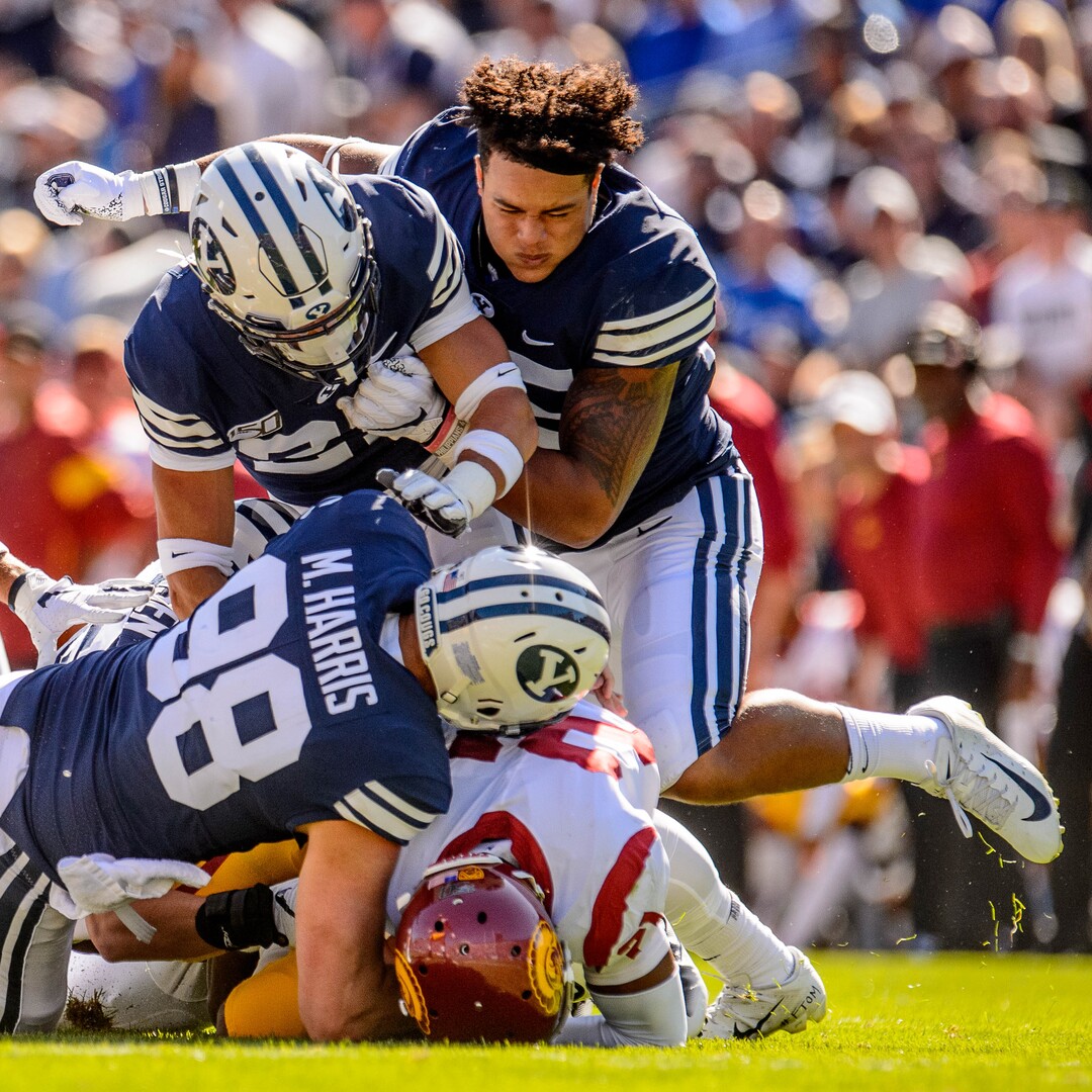 (Trent Nelson  |  The Salt Lake Tribune)  BYU defenders bring down USC Trojans safety Isaiah Pola-Mao (21) after he made an interception as BYU hosts USC, NCAA football in Provo on Saturday Sept. 14, 2019.