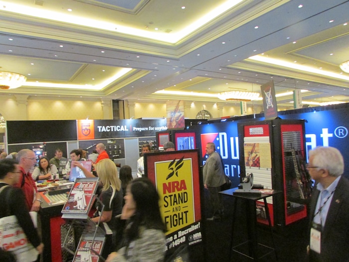 (Tom Wharton | Special to The Tribune)  A gun booth on Jan. 23, 2018 at the SHOT Show in Las Vegas with recruiting poster for the National Rifle Association.