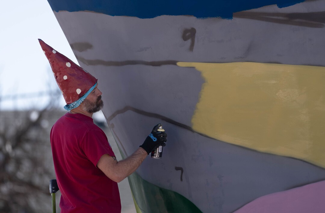 (Francisco Kjolseth | The Salt Lake Tribune) Local artist Mike Murdock paints the inaugural mural on Stephen Kesler’s “Out of the Blue,” a full-size sculpture of a humpback whale at the roundabout at 900 South and 1100 East on Thursday, April 7, 2022. The painted mural is inspired by the view of the Salt Lake Valley. 