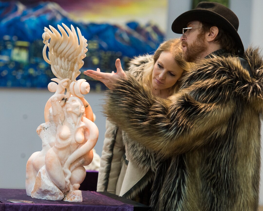 (Rick Egan  |  The Salt Lake Tribune)      Artist Mykael Lazzeri (right) talks about one of his art pieces with his wife Jamie, during the gallery stroll, at the Urban Arts Gallery, on Rio Grande Street, Friday, Nov. 16, 2018.