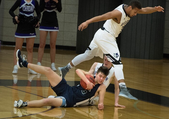 Scott Sommerdorf | The Salt Lake TribuneCopper Hills' Stone Hutchings goes to the floor to secure this second half loose ball. Copper Hills defeated Riverton 54-50, Friday, February, 2, 2018. 
