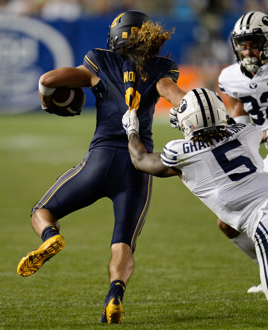 (Francisco Kjolseth  |  The Salt Lake Tribune)  California Golden Bears wide receiver Kanawai Noa (9) is pulled on by Brigham Young Cougars defensive back Dayan Ghanwoloku (5) during the second half of the NCAA college football game, Saturday, Sept. 8, 2018, at LaVell Edwards stadium in Provo, Utah.