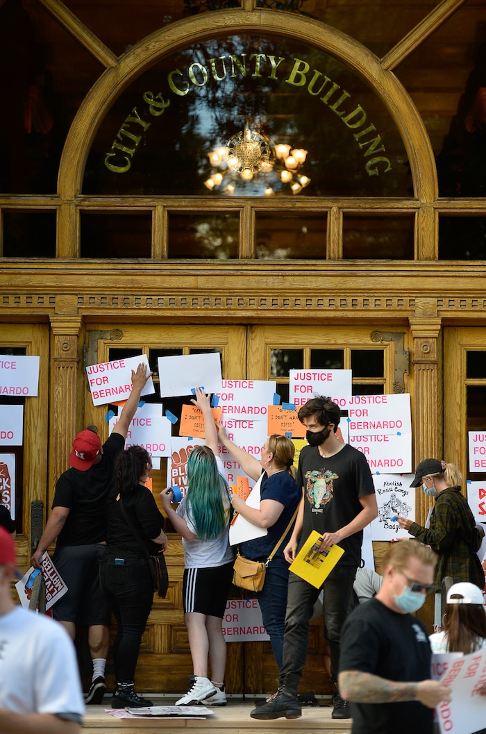 (Francisco Kjolseth  |  The Salt Lake Tribune) Demonstrators plaster City Hall with signs in Salt Lake City for a Justice for Bernardo Palacios Rally, on Thursday, June 18, 2020.