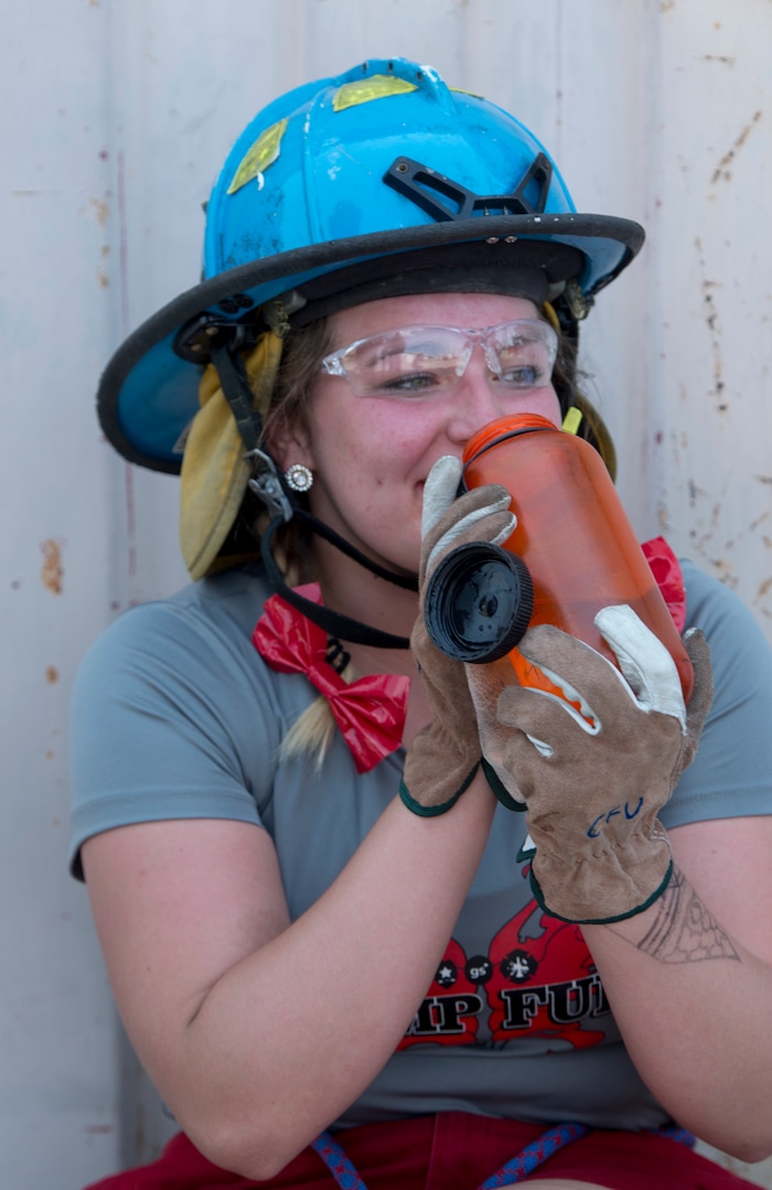 (Rick Egan  |  The Salt Lake Tribune)  Shelby takes a break for a drink of water, while attending Camp Fury.  A dozen Utah Girl Scouts participated in a 3-day camp led by female firefighters. Camp Fury Utah was developed in partnership with the Girl Scouts and local fire and police departments, designed to expose teen girls to careers in public safety and other non-traditional jobs. Saturday, August 5, 2017.



