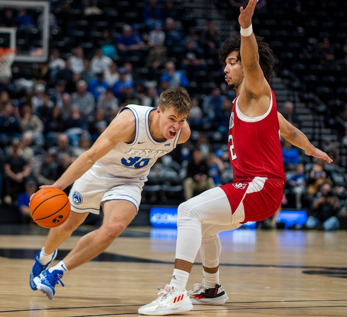 (Rick Egan | The Salt Lake Tribune)  Brigham Young Cougars guard Dallin Hall (30) tries to get past South Dakota Coyotes guard Damani Hayes (2), in basketball action between the Brigham Young Cougars and the South Dakota Coyotes, at Vivint Arena, in Salt Lake City, on Saturday, Dec. 3, 2022.
