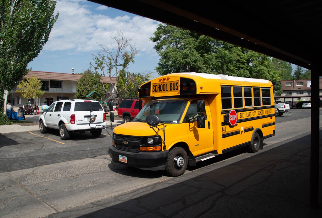 (Francisco Kjolseth | The Salt Lake Tribune) A small bus delivers lunches as the Salt Lake City School District sends staff to the Park Place Apartments on Tuesday, August 25, 2020, to help about 60 students who still needed to register for the fall.