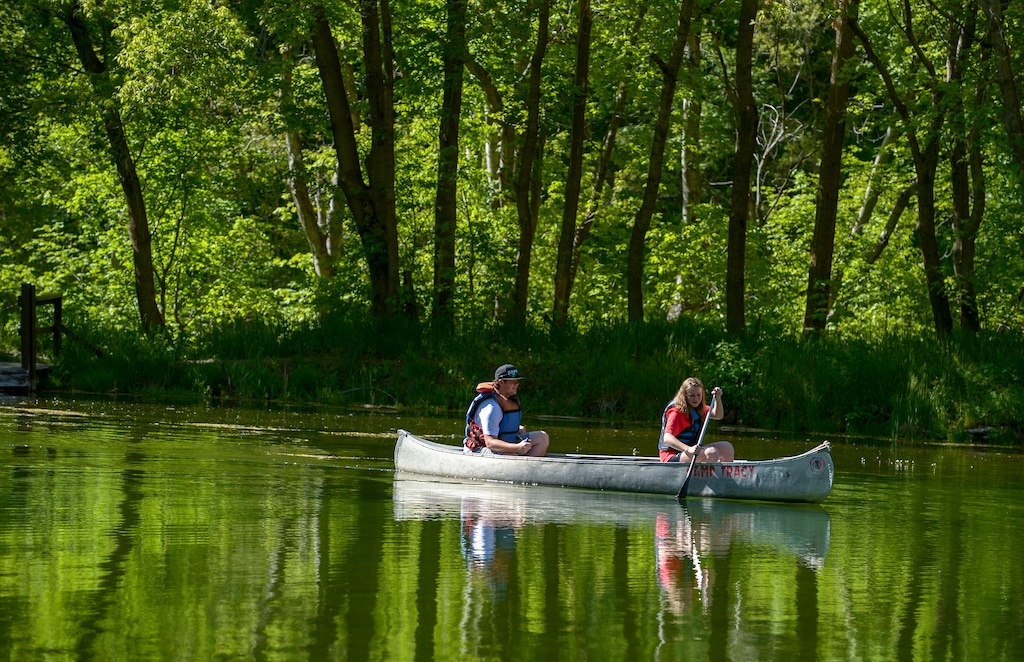 (Leah Hogsten  |  The Salt Lake Tribune) BSA Camp Tracy employees James Jette, 18, and Hensley Ballamis paddle around Taylor Lake, Thursday, May 24, 2018. The two will serve as lifeguards at Camp Tracy for the 2018 summer season. 