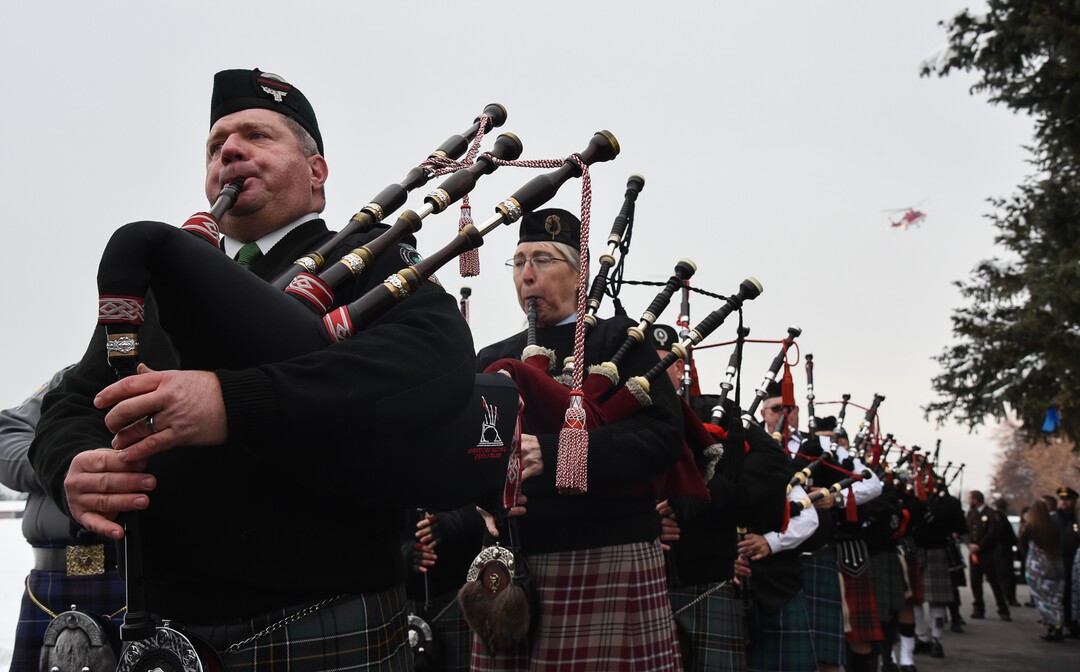 (Francisco Kjolseth  |  The Salt Lake Tribune)  The bagpipes play during a helicopter fly over in honor of police officer David Romrell during funeral services at Larkin Sunset Gardens Cemetery in Sandy, Wed. Dec. 5, 2018.