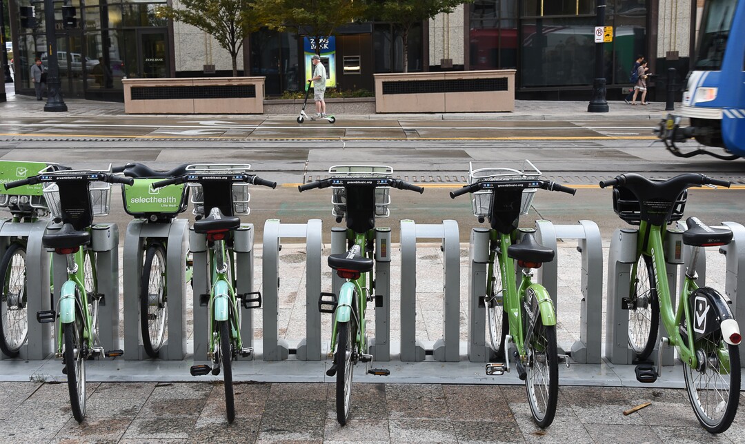 (Francisco Kjolseth  |  The Salt Lake Tribune)  An electric scooter rider scoots along in downtown Salt Lake City on Tuesday, Oct. 2, 2108. GreenBike was on track to have their best year yet but then Lime and Bird scooters derailed their momentum.