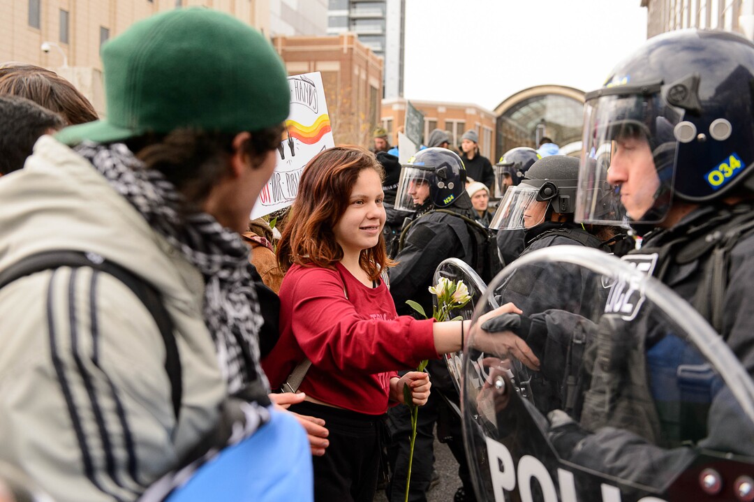 (Trent Nelson | The Salt Lake Tribune)  A protester shakes hands with a police officer after a rally against a visit by President Donald Trump, Monday December 4, 2017.