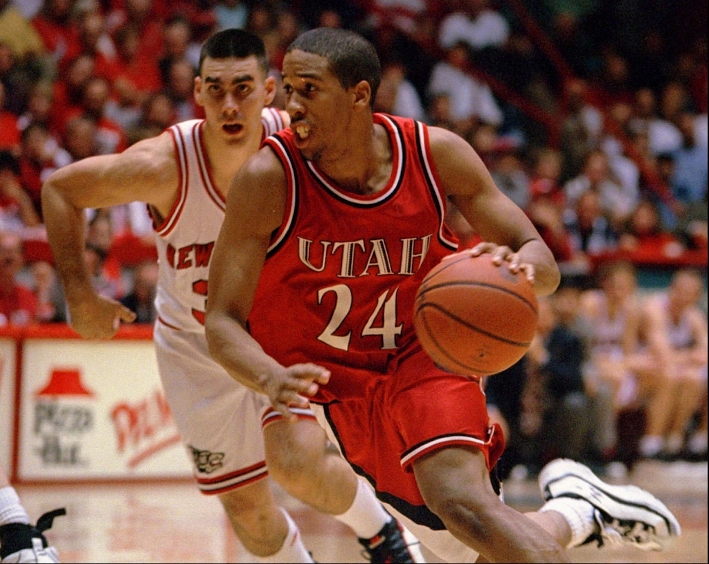 Utah's Andre Miller evades University of New Mexico's Royce Olney during their game Sunday, Feb. 1, 1998, in Albuquerque, N.M.   Number fourteen ranked New Mexico upset Utah, 77-74.  (AP Photo/Pat Vasquez-Cunningham)