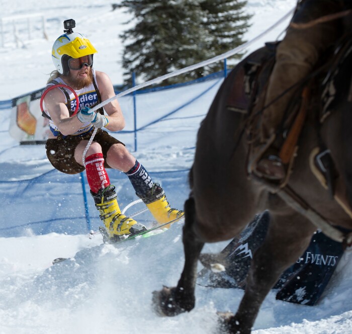 (Rick Egan | The Salt Lake Tribune) Caden Spencer is pulled by Jake Ream, riding Cadillac the horse, for the team "Snow Choppers", in the first day of the Skijoring competition at Soldier Hollow Friday. Feb. 22, 2019. The competition continues on Saturday.