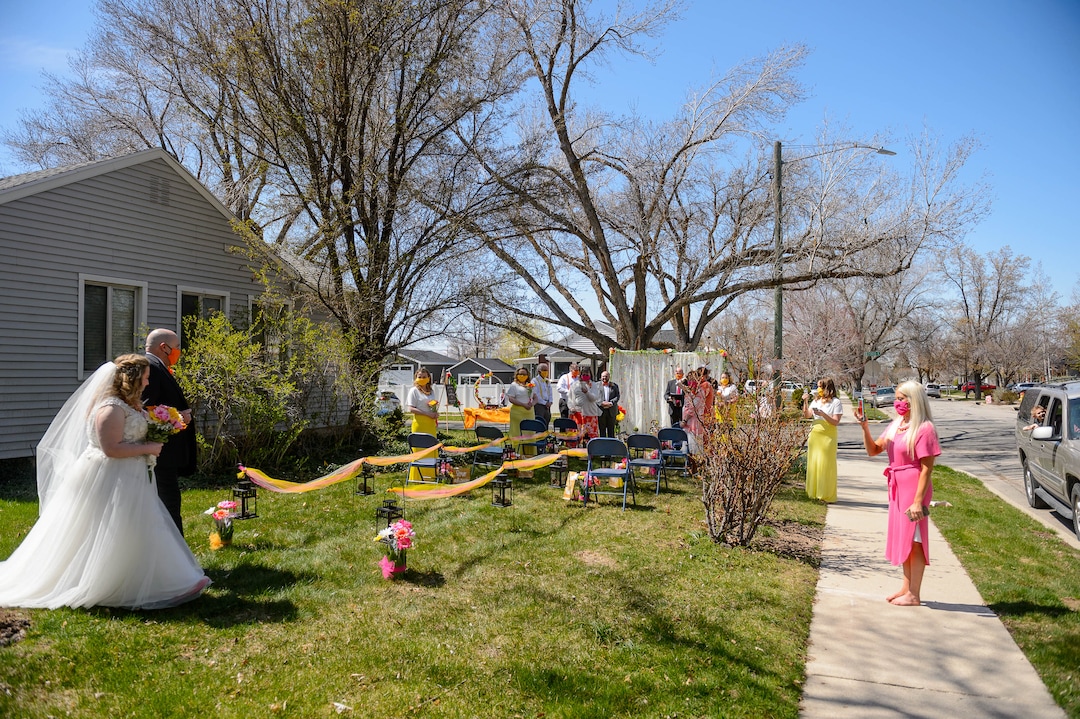 (Trent Nelson  |  The Salt Lake Tribune) Kadie Smeding walks the aisle to marry her fiance Tyler van Roosendaal in a Salt Lake City yard on Saturday, April 4, 2020.
