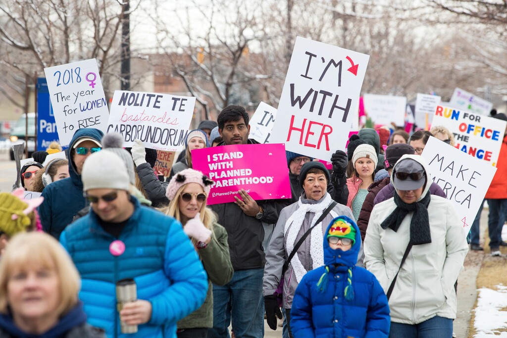 (Bryan Butterfield  |  Standard-Examiner via AP) 
 People hold signs during a Women's March in Ogden, Utah, Saturday, Jan. 20, 2018. On the anniversary of President Donald Trump’s inauguration, people participating in rallies and marches in the U.S. and around the world Saturday denounced his views on immigration, abortion, LGBT rights, women's rights and more.