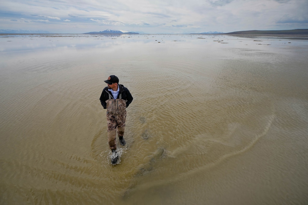 (Francisco Kjolseth | The Salt Lake Tribune) Ducks Unlimited Regional Director Chad Yamane walks the shallow edges of the Great Salt Lake near the outflow of the Weber River following a record breaking snow year on Wednesday, April 12, 2023. Critical wetlands that were bone-dry just weeks before have slowly come back with a few inches of water, as much attention is paid to how much the terminal lake will recover.