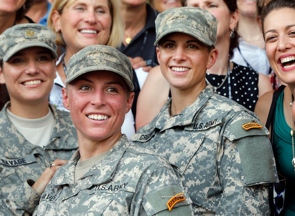 U.S. Army First Lt. Shaye Haver, center, and Capt. Kristen Griest, right, pose for photos with other female West Point alumni after an Army Ranger school graduation ceremony, Friday, Aug. 21, 2015, at Fort Benning, Ga. Haver and Griest became the Army's first female graduates of the Army's rigorous Ranger School, putting a spotlight on the debate over women in combat. (AP Photo/John Bazemore)