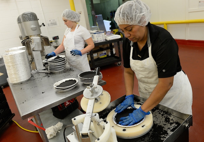 Francisco Kjolseth | The Salt Lake TribuneVictoria Gillespie, in background, and Rosa Rebolledo hand assemble hydrox chocolate cookie crusts at the Rocky Mountain Pie factor in Salt Lake recently. 