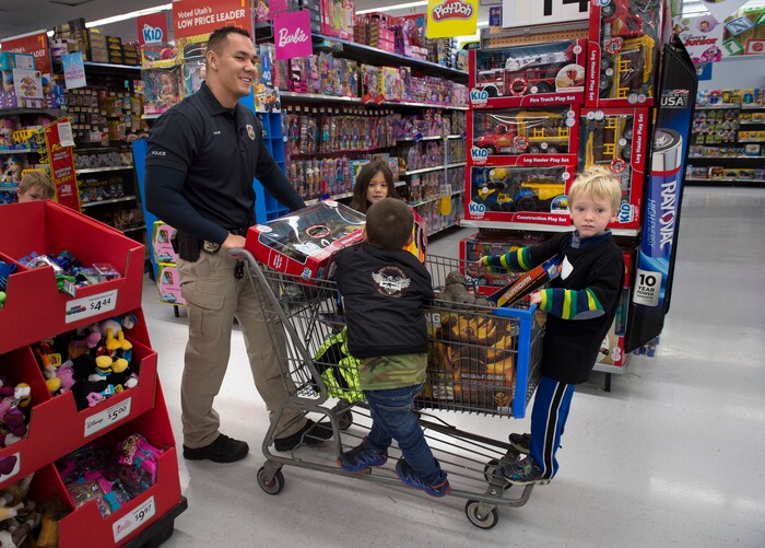 (Scott Sommerdorf   |  The Salt Lake Tribune)   Officer William Chow solved the transportation challenge while shopping at the first ever Police Pay It Forward event, Saturday, December 16, 2017.  
