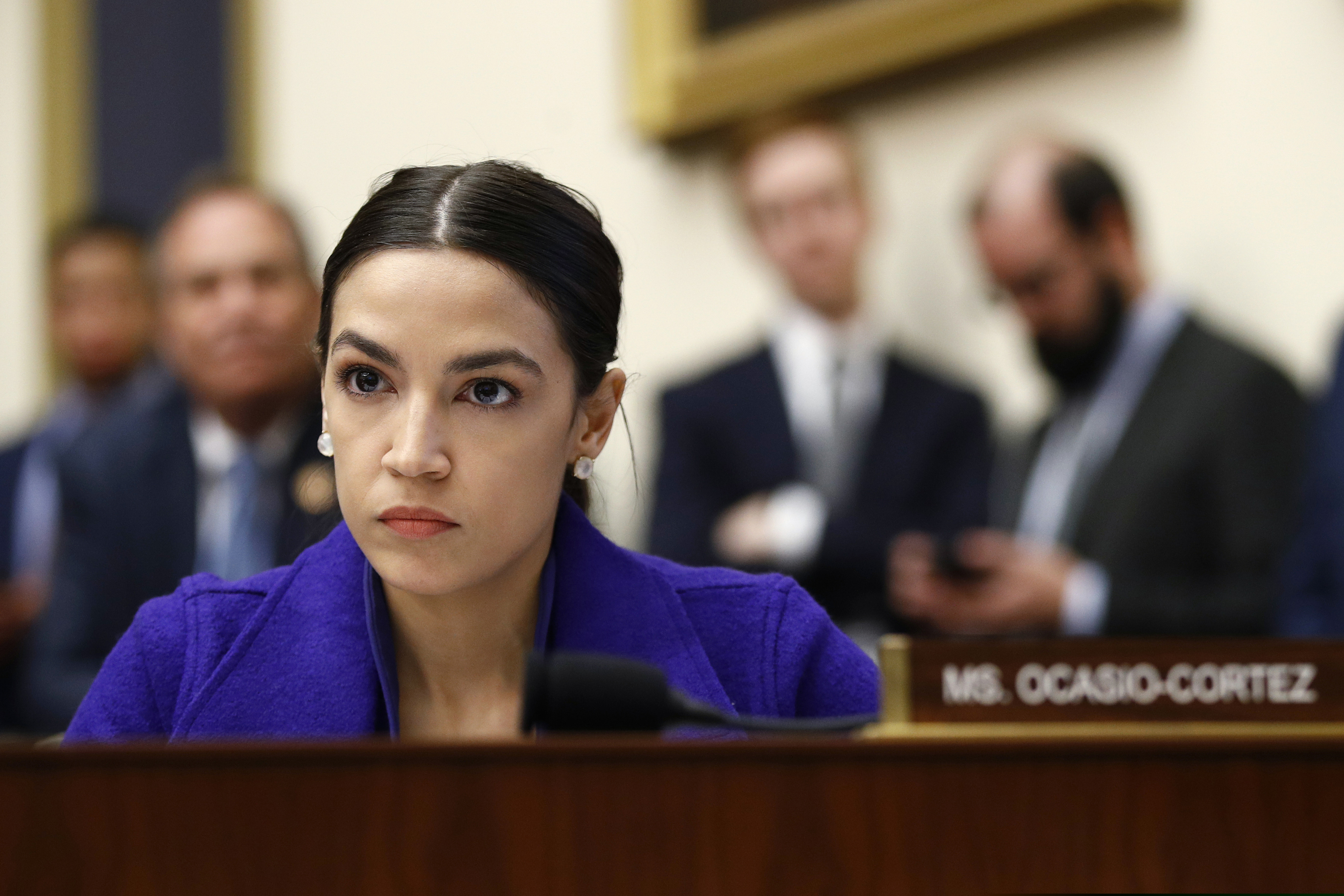 FILE - In this Wednesday, April 10, 2019, file photo, Rep. Alexandria Ocasio-Cortez, D-N.Y., listens during a House Financial Services Committee hearing with leaders of major banks on Capitol Hill in Washington. A company has cut ties with a California minor league baseball team that played a Memorial Day video that included an image of Democratic Rep. Alexandria Ocasio-Cortez with those of Kim Jong Un and Fidel Castro. The Fresno Bee reports the raisin company Sun-Maid terminated its sponsorship of the Fresno Grizzlies on Wednesday, May 29. (AP Photo/Patrick Semansky, File)
