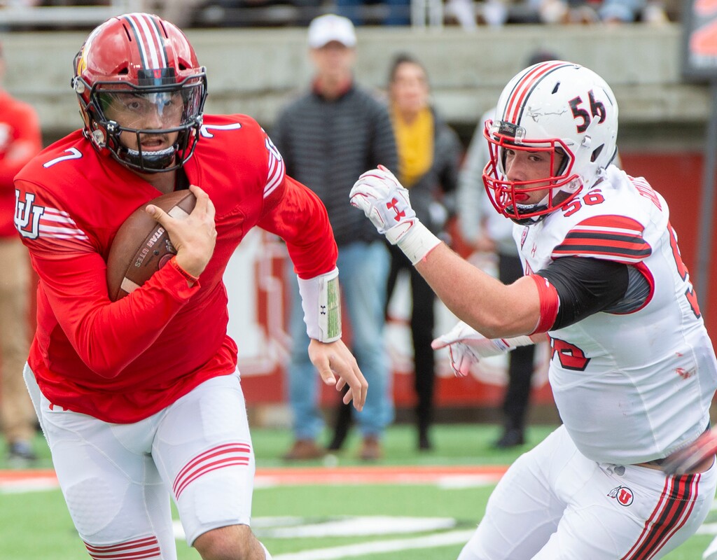 (Rick Egan  |  The Salt Lake Tribune)  Quarterback Cameron Rising runs the ball, as lineman Paul Maile defends, in Utah's spring Red-White game at Rice-Eccles Stadium, Saturday, April 13, 2019.
