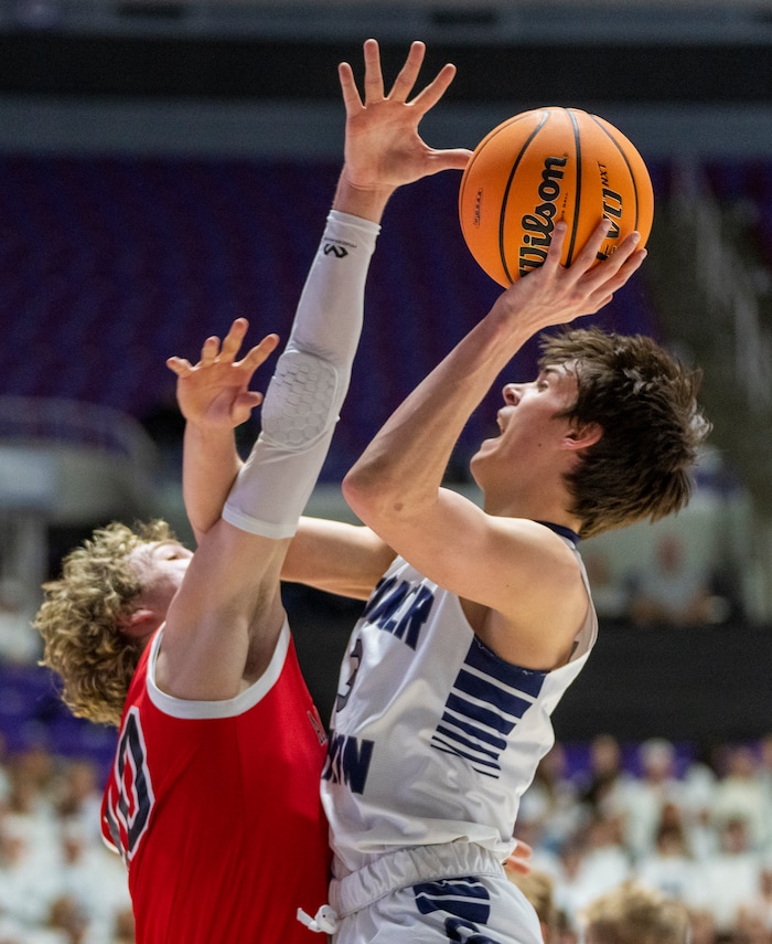 (Rick Egan | The Salt Lake Tribune) Peterson Lunt, Corner Canyon shoots as  Ashton Wallace defends for American Fork, in the Boys 6A State Championship at Weber State, on Saturday, March 4, 2023.