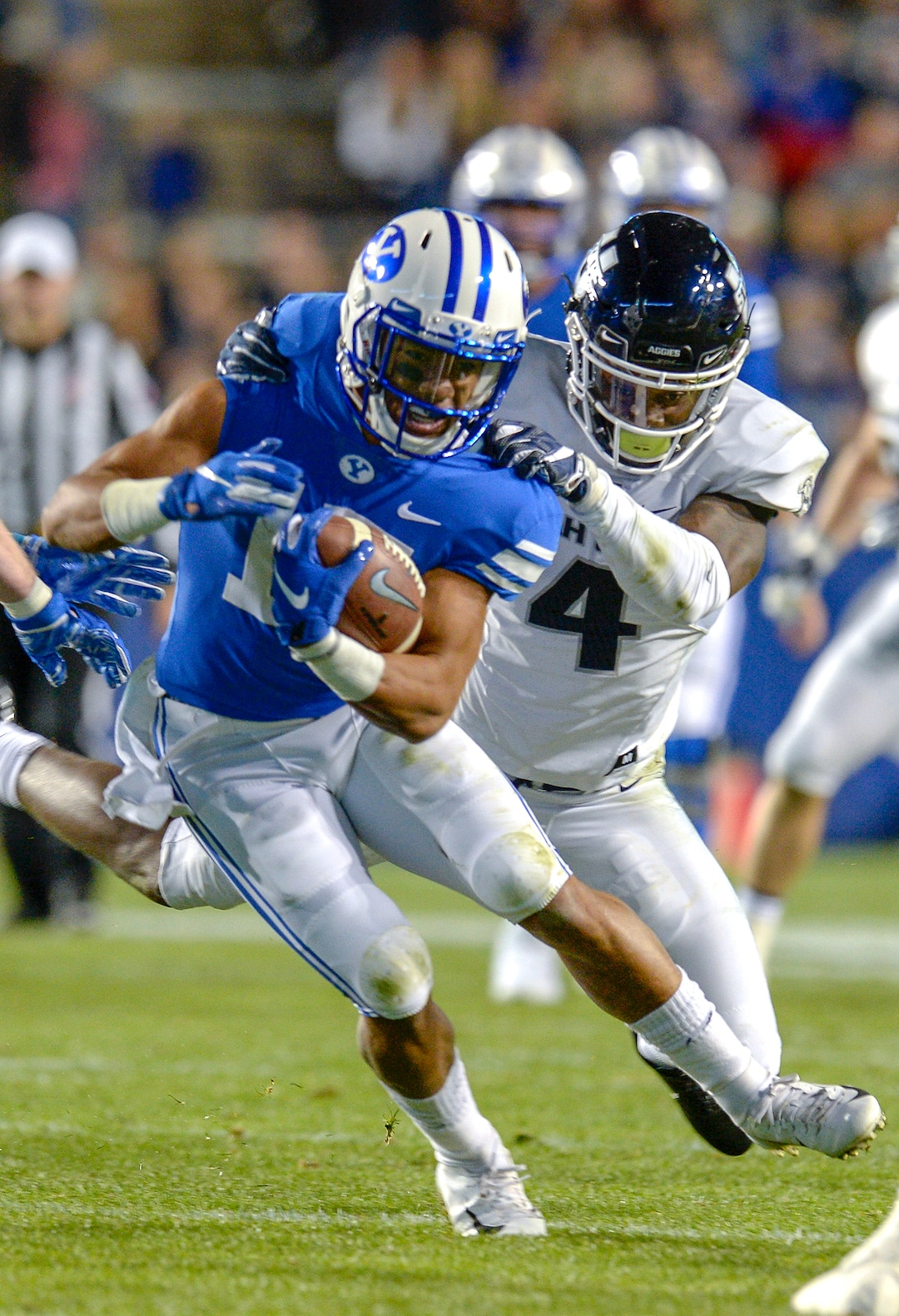 Leah Hogsten  |  The Salt Lake Tribune  Brigham Young Cougars wide receiver Aleva Hifo (15) is brought down by Utah State Aggies safety Aaron Wade (4) as BYU hosts Utah State University at Lavell Edwards Stadium in Provo, Friday, Oct. 5, 2018.