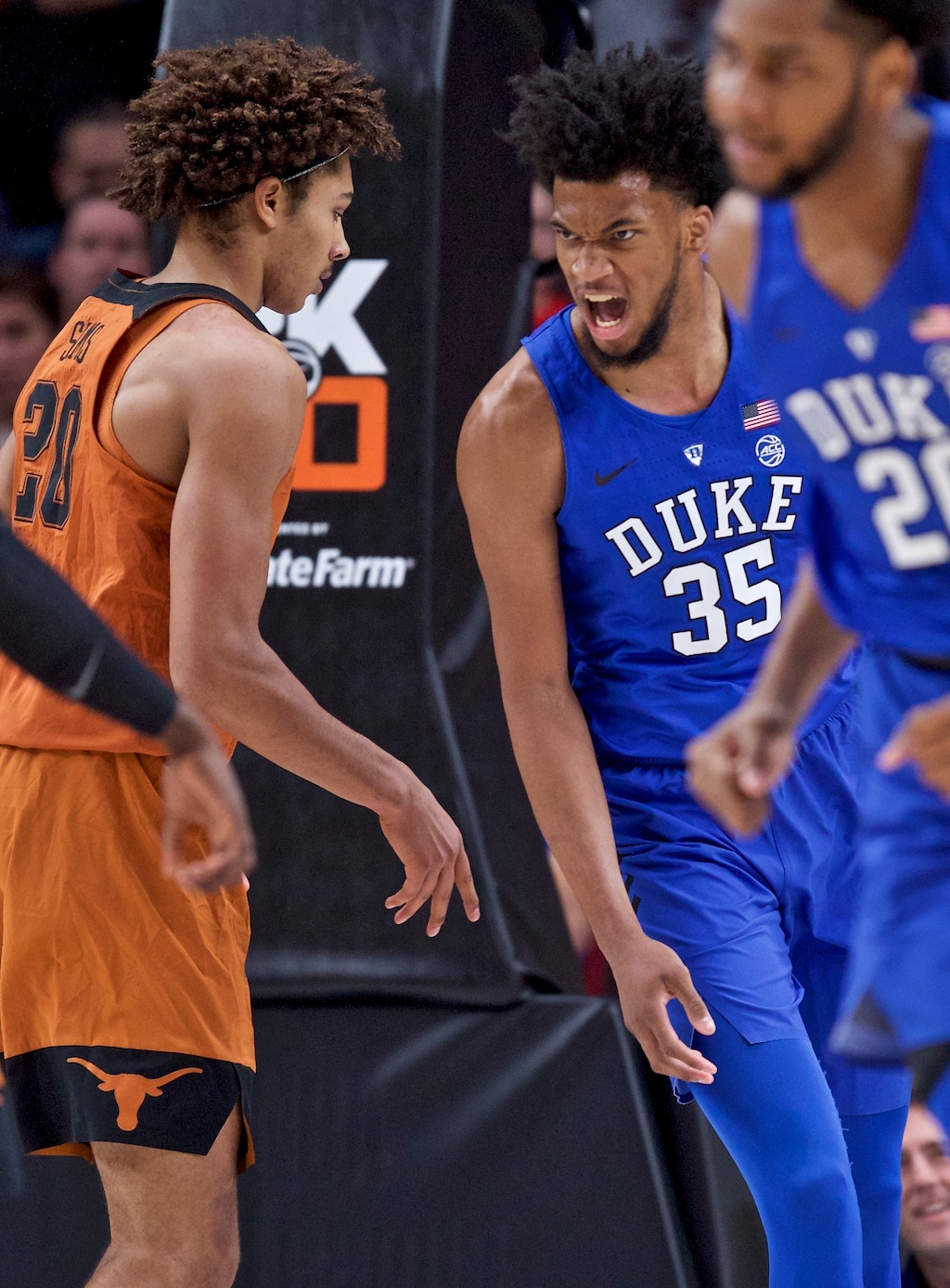 Duke forward Marvin Bailey III, right, reacts after dunking over Texas forward Jericho Sims during the first half of an NCAA college basketball game in the Phil Knight Invitational tournament in Portland, Ore., Friday, Nov. 24, 2017. (AP Photo/Craig Mitchelldyer)